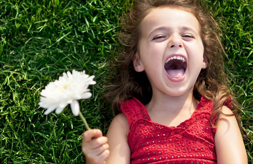 We're proud to offer pediatric dentistry services in Redding, CA and Red Bluff CA. A young girl smiling after her pediatric dentistry appointment.